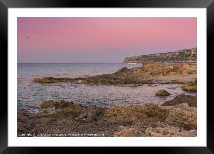 Sunset on the rocky coast with anchored sailboat Framed Mounted Print by Vicente Sargues