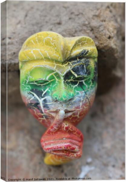 A Balinese mask puts a finger on mouth for secret  Canvas Print by Hanif Setiawan