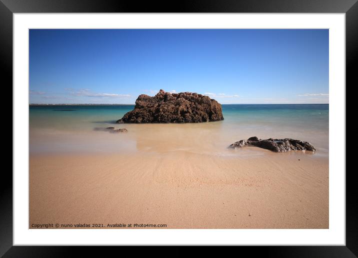 Sandy Beach with turquoise sea water with rocks. l Framed Mounted Print by nuno valadas