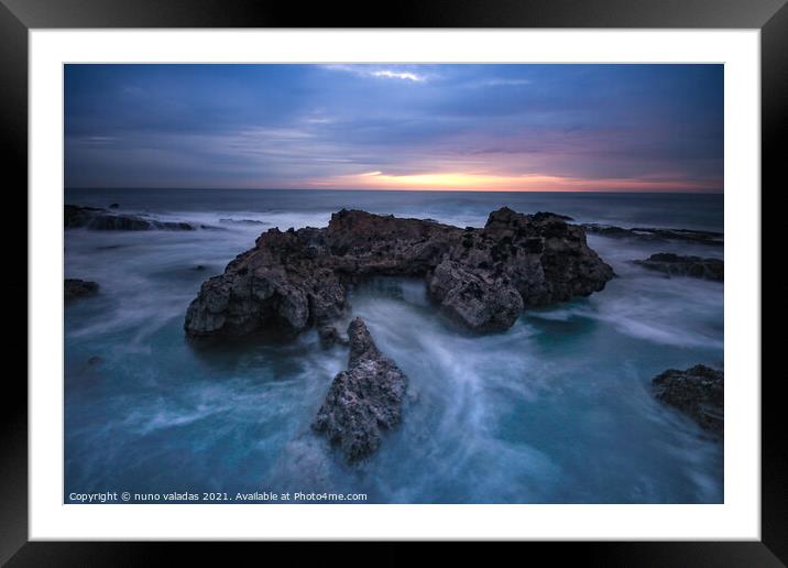 Ocean waves hit in a rock in a stormy day at the sunset. Framed Mounted Print by nuno valadas