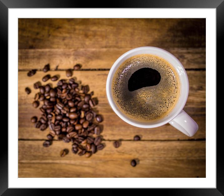 Freshly brewed cup of coffee on a wooden table Framed Mounted Print by Erik Lattwein