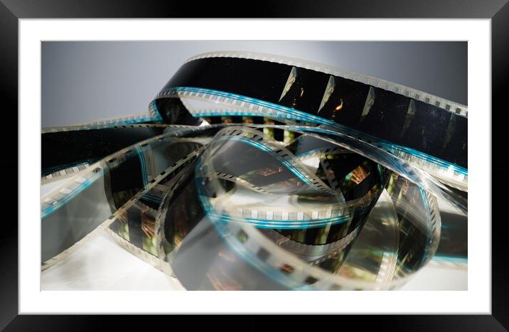 Close Up view of a 35mm film strip - macro shot Framed Mounted Print by Erik Lattwein