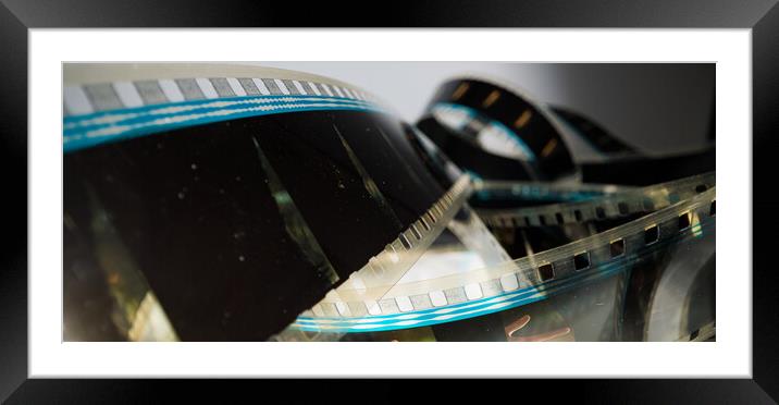 Movie background - 35mm film strip macro view Framed Mounted Print by Erik Lattwein