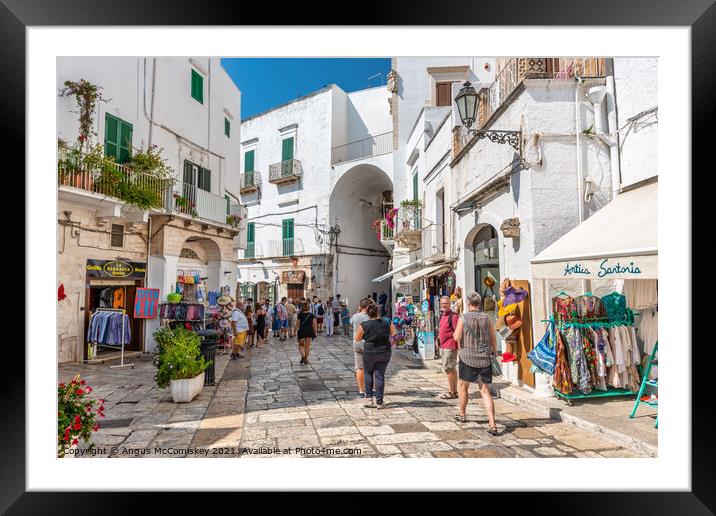 Tourists on Via Cattedrale in Ostuni, Italy Framed Mounted Print by Angus McComiskey