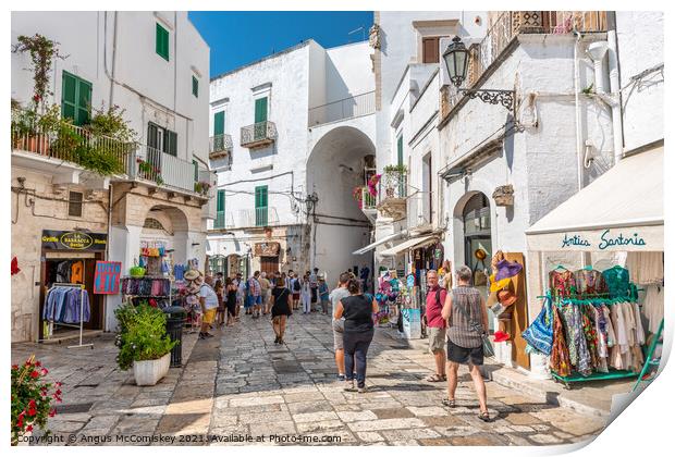 Tourists on Via Cattedrale in Ostuni, Italy Print by Angus McComiskey