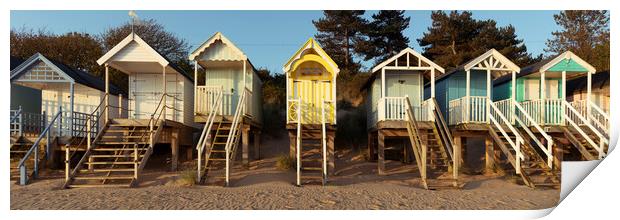 Colorful wells next the sea beach huts England Print by Sonny Ryse