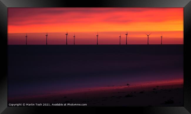 Electric. Orange dawn with wind farm and beach Framed Print by Martin Tosh