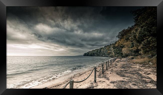 Dark Skies over the beach Framed Print by Ian Johnston  LRPS