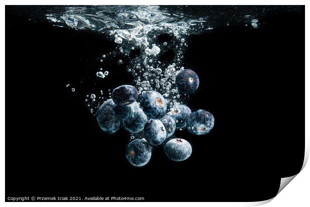 Blueberries splashing in water on black Print by Przemek Iciak