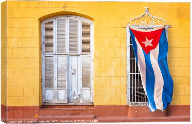 Cuban flag in in a street of Trinidad, Cuba Canvas Print by Delphimages Art