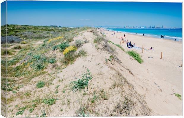 Valencia, Spain - April 21, 2021: Vacationers on a beach, next t Canvas Print by Joaquin Corbalan