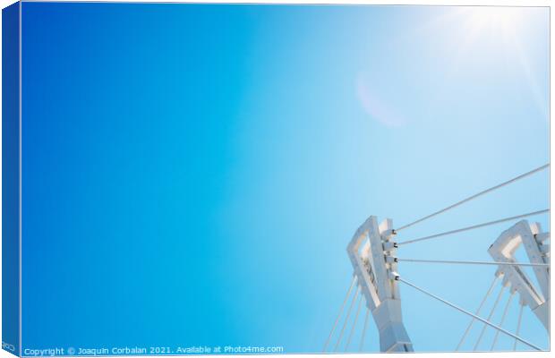 Blue sky ripped into a corner by the top of a modern metal bridg Canvas Print by Joaquin Corbalan