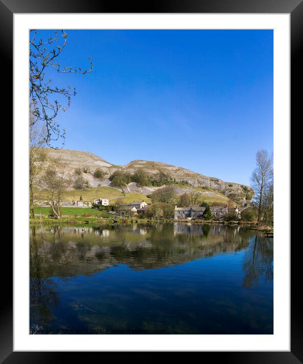 Kilnsey Trout Farm Lake with Kilnsey Crag in the background. Framed Mounted Print by Chris North