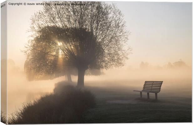Bench beside misty lake Canvas Print by Kevin White