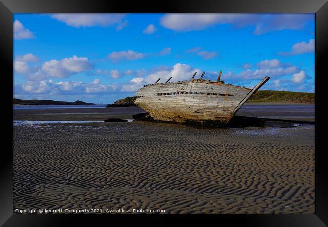 A shipwreck sitting on top of a sandy beach Framed Print by kenneth Dougherty