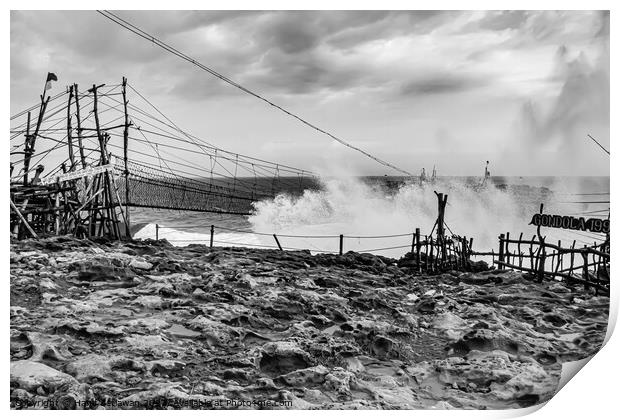 Big wave hits swinging rope foot bridge to island Print by Hanif Setiawan