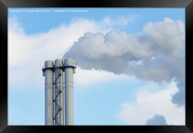 Emissions of smoke and steam from an industrial chimney into a clear sky. Framed Print by Sergii Petruk