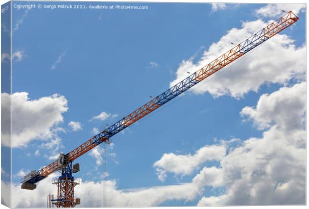An arrow of a tower crane against a blue sky, divides the image diagonally. Canvas Print by Sergii Petruk