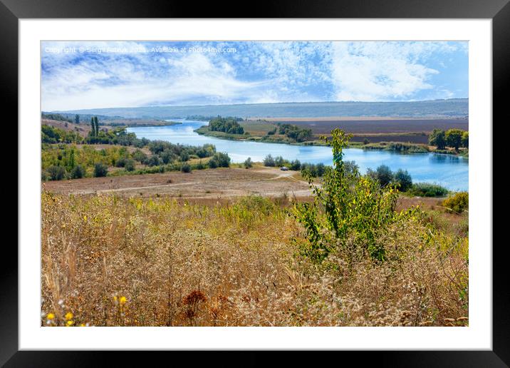 A beautiful summer landscape with a winding river between fields and hills and a blue, slightly cloudy sky. Framed Mounted Print by Sergii Petruk