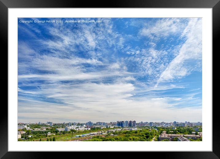 Panorama of the city under a high beautiful blue sky with light white curly clouds. Framed Mounted Print by Sergii Petruk
