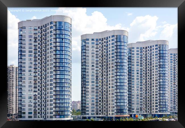 Tall houses of white-blue high-rise buildings in a new district of the city. Framed Print by Sergii Petruk