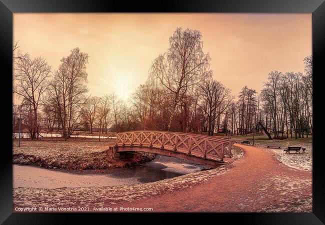Sunset over wooden bridge in city park Framed Print by Maria Vonotna