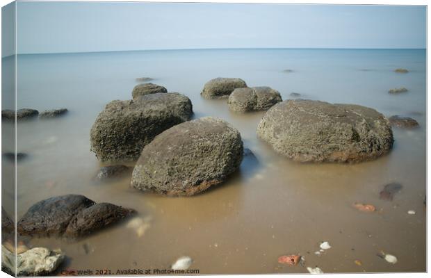 Boulders on smooth sea Canvas Print by Clive Wells
