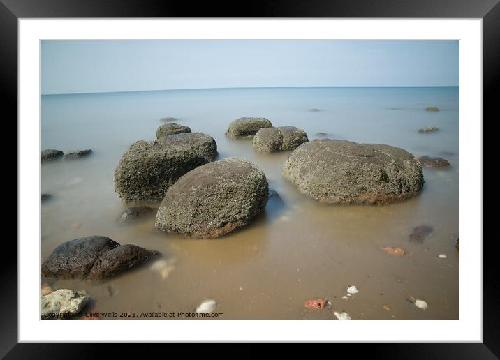 Boulders on smooth sea Framed Mounted Print by Clive Wells