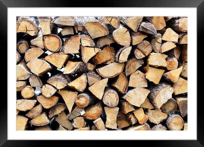Roughly chopped wood, neatly stacked on top of each other. Framed Mounted Print by Sergii Petruk