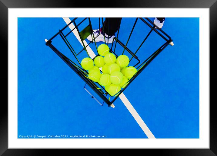 Basket full of yellow tennis balls for training tennis players o Framed Mounted Print by Joaquin Corbalan