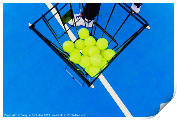 Basket full of yellow tennis balls for training tennis players o Print by Joaquin Corbalan