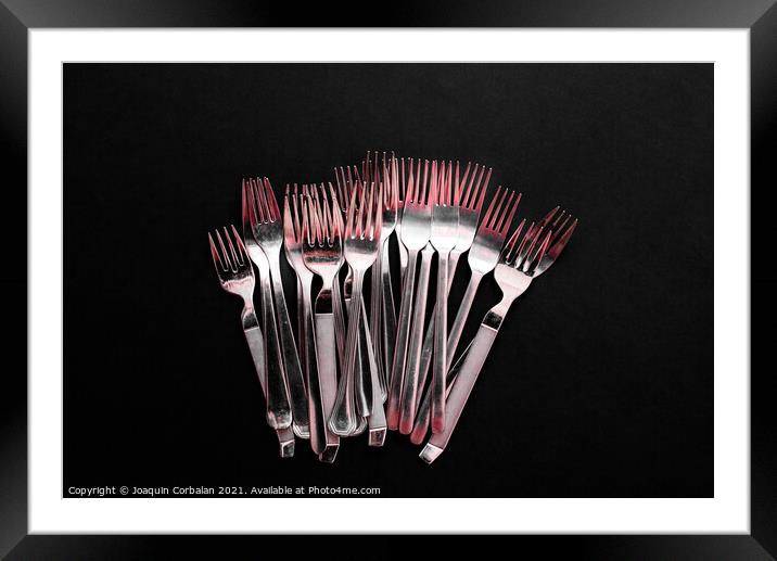 Simple and modern design forks viewed from above on clean black  Framed Mounted Print by Joaquin Corbalan