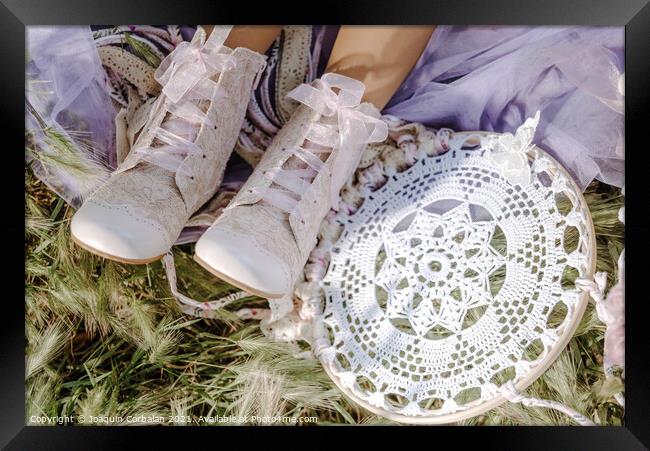 Boots on the feet of a girl who rests in the fresh grass next to Framed Print by Joaquin Corbalan