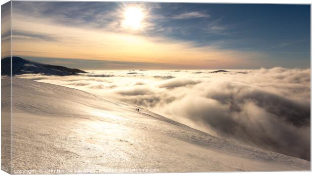 Winter walking Above the clouds Canvas Print by John Henderson
