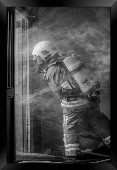 Firefighter Working in Smoke Framed Print by Roger Green