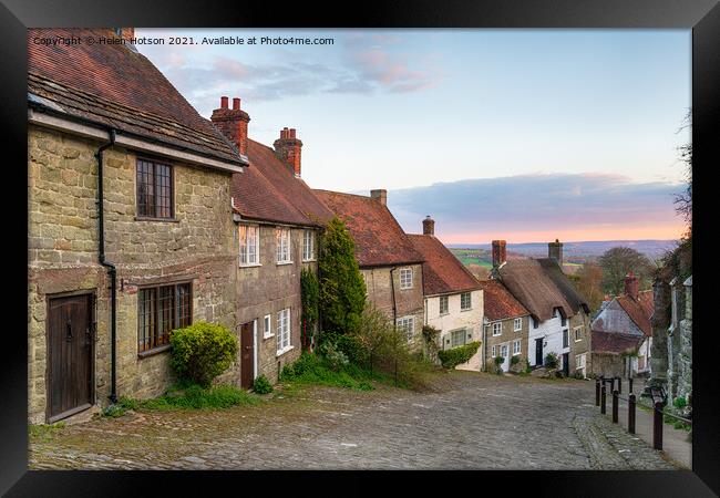 Sunset over cottages on a cobbled street Framed Print by Helen Hotson