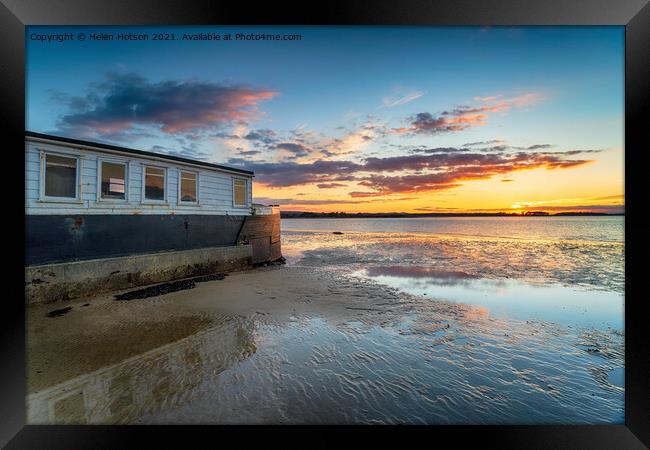 Sunset over an old boat on Bramble Bush Bay at Studland in Poole Framed Print by Helen Hotson