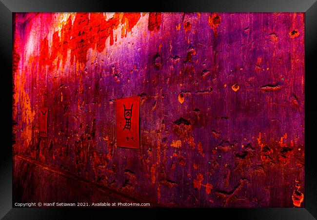 Small red poster with Chinese script on a violet wall. Framed Print by Hanif Setiawan
