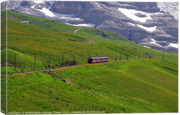 The famous tourist train grazing on a lush green hillside Canvas Print by PhotOvation-Akshay Thaker