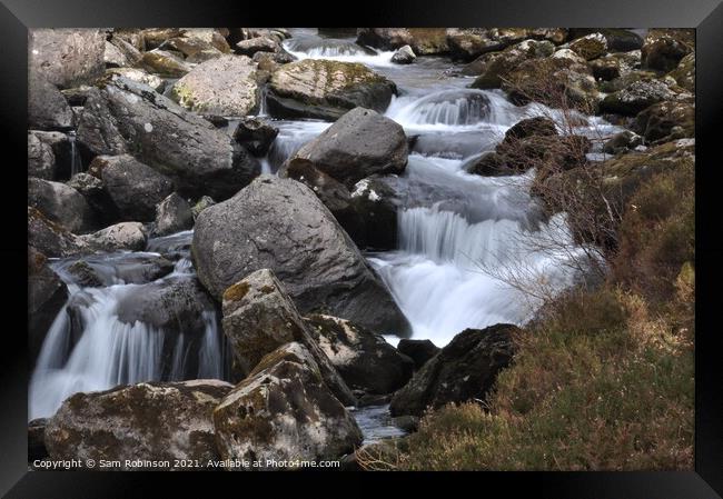 Stream flowing over rocks Framed Print by Sam Robinson