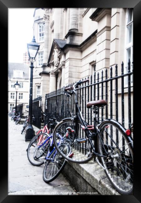 Bikes Chained Up Against Railings Outside Oxford University Coll Framed Print by Peter Greenway