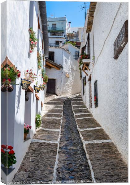 Narrow alleyway in Pampaneira, Andalusia, Spain Canvas Print by Angus McComiskey