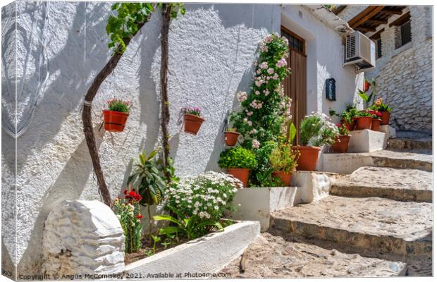 Colourful alleyway in Pampaneira, Andalusia, Spain Canvas Print by Angus McComiskey