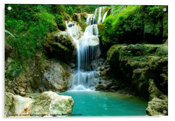 A waterfall flowing over rocks into a river. Acrylic by Hanif Setiawan