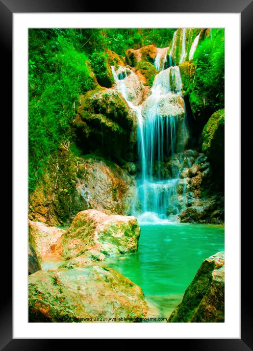 A waterfall flowing over rocks into a river. Framed Mounted Print by Hanif Setiawan