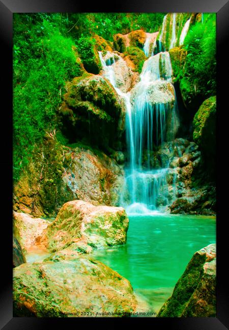 A waterfall flowing over rocks into a river. Framed Print by Hanif Setiawan