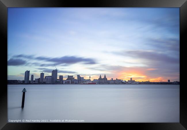 The sun rising over the skyline of Liverpool Framed Print by Paul Hanley