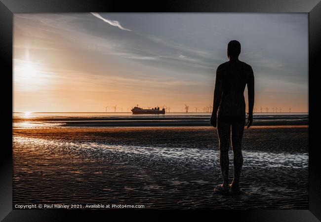 A lonely figure stands guard over the shipping Framed Print by Paul Hanley