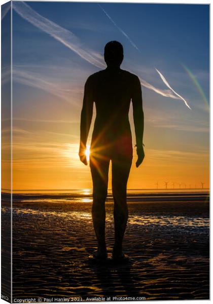 A lonely figure stands silent on Crosby beach Canvas Print by Paul Hanley