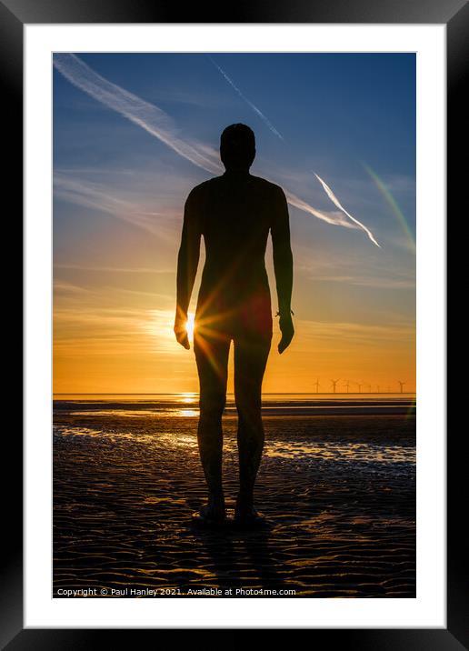 A lonely figure stands silent on Crosby beach Framed Mounted Print by Paul Hanley